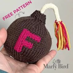 a hand holding a small crocheted bag with a tassel