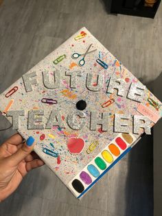 someone holding up a graduation cap with the words future teacher written on it