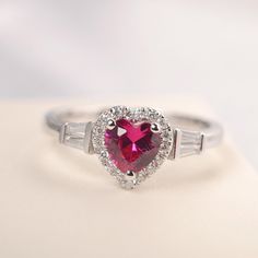 All HANDMADE ITEMS SHIP IN APPROX 8 DAYS Main Stone: Lab created ruby Main Stone Size: Heart cut 6 mm x 6mm Main Stone Weight: 1.16 carat Side Stone: CZs Height From The Ring Setting Bottom(to gemstone top): about 5.25 mm Width of Ring band Measure: gradually varied,about 2.08 to 2.31 mm Material: .925 Sterling Silver/14K White Gold/14K Yellow Gold/14k Rose Gold Engraved: Available For FreeNo more than 13 letters) Customized:Of course! Tell me what you want Includes With Order: All of my store i Red Diamond Heart Ring For Anniversary, Red Heart Diamond Ring For Anniversary, Red Heart Shaped Diamond Anniversary Ring, Heart-shaped Diamond Ring For Anniversary, Valentine's Day Pink Ruby Ring, Red Heart Ring With Center Stone For Wedding, Red Heart Ring With Center Stone, Heart Cut Diamond Ruby Ring For Promise, Red Heart-shaped Rings With Center Stone