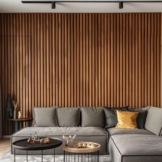 a living room with a couch, coffee table and wooden wall