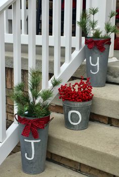 two buckets with christmas decorations on the steps