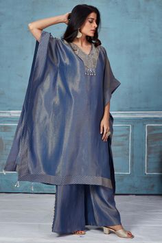 Turn heads at weddings and special occasions in this stylish blue embroidered tissue georgette kaftan and pant set. DISCLAIMER: The actual product may vary slightly from the image. These are custom orders, hence expect slight variation in color and placement of the motif or buta. ESTIMATED DELIVERY: Because this is a custom order, it would take about 4 weeks from the date of purchase. RETURN POLICY: This product is a custom order and cannot be returned or exchanged. Elegant Blue Pant Set With Resham Embroidery, Elegant Blue Embroidered Pant Set, Blue Resham Embroidered Pant Set For Wedding, Blue Resham Embroidery Pant Set For Wedding, Festive Blue Straight Kurta Pant Set, Festive Blue Pant Set With Straight Kurta, Blue Wedding Pant Set With Resham Embroidery, Blue Unstitched Pant Set For Eid, Blue Palazzo Set With Chikankari Embroidery For Reception