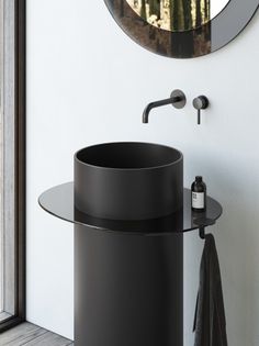 a bathroom with a round sink and mirror