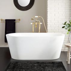 a white bath tub sitting on top of a black rug