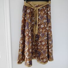 Beautiful Long Wrap Skirt From Shinawatra (The Oldest Silk Factory In Thailand). Pattern In Shades Of Purple, Yellow-Orange, And Brown. 100% Silk. No Size Listed But Would Fit S/M. Bohemian Orange Skirt With Elastic Waistband, Orange Bohemian Skirt With Elastic Waistband, Bohemian Orange Skirted Bottoms, Orange Bohemian Skirted Bottoms, Bohemian Orange Lined Skirt, Long Wrap Skirt, Shades Of Purple, Yellow Orange, Wrap Skirt