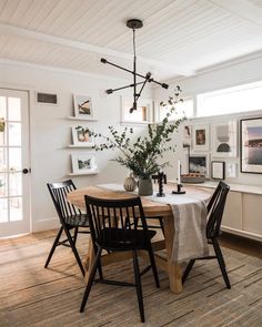 a dining room table with four chairs around it