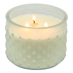 a white candle with three lit candles in it