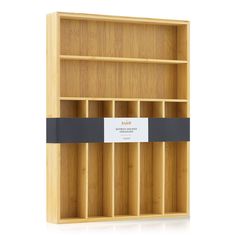 an empty wooden shelf with labels on the bottom and black ribbon around it's edges