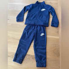 Never Worn! Navy Blue, Zip Up, Two Piece Sweatsuit. Two Pockets In The Top, Elastic Waist Band. Blue Sportswear Loungewear Sets, Blue Long Sleeve Sportswear Sets, Nike Loungewear Sets, Fitted Nike Sports Sets, Nike Fitted Sports Sets, Nike Fitted Sportswear Sets, Nike Blue Cotton Sets, Nike Blue Playtime Sets, Nike Long Sleeve Blue Set