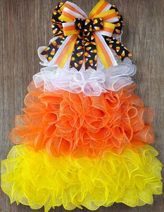 an orange, yellow and white tulle skirt with polka dots on the bottom layer