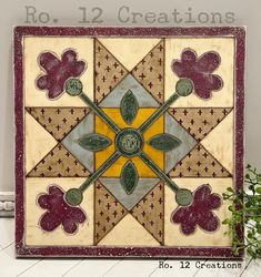 a decorative wall hanging with flowers on it