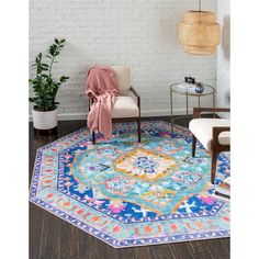 a living room area with a rug, chair and potted plant