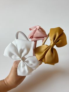 These headband bows are timeless and comfortable for babies and toddlers. They come in three colors. Playful Adjustable Bow Headband, Adjustable White Bow Tie With Decorative Bow, White Adjustable Hair Accessories, Adjustable Detachable White Bow, Adjustable Bow With Matching Headband For Spring, White Headband For Spring Playtime, White Bow With Matching Headband, Adjustable White Headband For Playtime, White Headband With Bow Tie