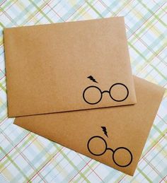 two brown envelopes with harry potter glasses drawn on them