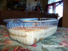 a plastic container filled with food sitting on top of a table next to a couch