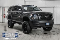 a black truck is parked in a garage