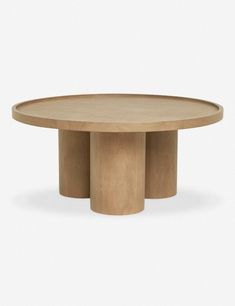 a round wooden table with three legs