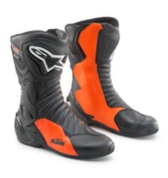 a pair of black and orange motorcycle boots