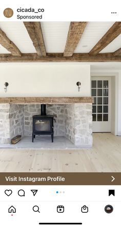 a room with a stone fireplace and wooden beams on the ceiling is shown in an instagram