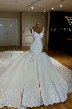 a white wedding dress on display in a room