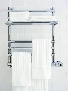 two white towels are hanging on a towel rack