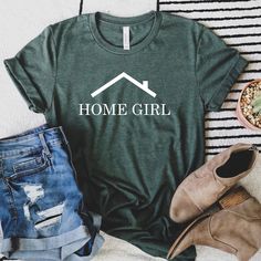 a t - shirt that says home girl next to some jeans and shoes on a bed