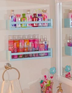 the bathroom is decorated in pastel colors and has shelves filled with personal care products