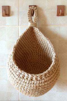 Hanging wall basket with beautiful loop is  perfect rustic kitchen decor.
This hanging basket is quite sturdy, and keep its form well. 
Hanging basket made of eco-friendly material in neutral colors of jute and will decorate Scandinavian, rustic, farmhouse or modern interior.
You can store potatoes, apples, onions, garlic, nuts or other vegetables and fruits in this hanging basket.  Baskets is also good as a plant holder. Macrame Hanging Basket Diy Free Pattern, Crochet Hanging Baskets Free Patterns, Hanging Crochet Basket, Easy Crochet Basket, Crochet Basket Patterns, Easy Crochet Basket Pattern, Hanging Wall Baskets, Hanging Fruit Baskets, Crochet Storage Baskets