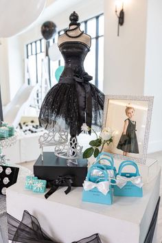 a dress and shoes are on display in a room with black and white decor,