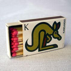 a match box with matches in it and a kangaroo on the front, inside which is red