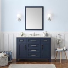 a bathroom vanity with a mirror above it and two lights on the wall next to it