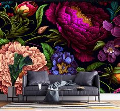 a living room scene with a couch and flower wall mural on the wall behind it