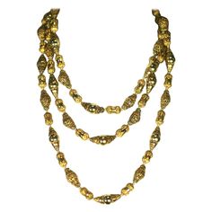 Coco Chanel Gilt Filigree Bead Long Necklace, Goossens. Long chain with gilt filigrees stacked and layered with polished gilt beads. A subtle play on matte and shiny in a long, transformable hand knotted bead necklace. 56" x 3/8". 1960's France, Unsigned. Excellent condition. Necklaces Beaded, Good Luck Necklace, Coral Beads Necklace, Evil Eye Necklace Gold, Dainty Diamond Necklace, Chanel Necklace, Key Pendant Necklace, Diamond Evil Eye, Vintage Beads Necklace