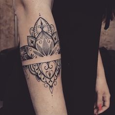 a woman's arm with a tattoo on it and a cross in the middle