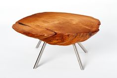 a wooden stool with metal legs on a white background