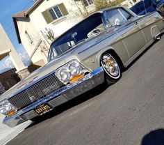 an old car is parked on the street