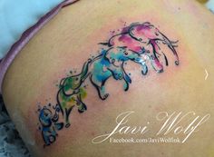 an elephant tattoo on the back of a woman's stomach