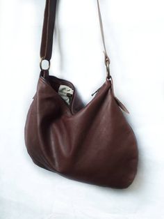 Leather mini hobo bag made with brown soft leather. The bag is closed with a metallic zip. Inside is unlined and there is a large cotton zipped pocket. There is an adjustable shoulder strap made with stronger brown leather. Features : - Brown leather, - Zipped bag, - Unlined, - Inside cotton zipped pocket, Size: - Height 10 inch, - Lenght 14 inch, - Shoulder belt is adjustable. Contact me for any information --------------------------------------- The shipping is made after 3 days by the purchas Brown Leather Lining Hobo Bag For Everyday Use, Brown Soft Leather Hobo Bag For Everyday, Leather Hobo Bag With Zipper Closure, Brown Crossbody Hobo Bag For Everyday, Everyday Brown Crossbody Hobo Bag, Brown Soft Leather Hobo Bag For Daily Use, Brown Hobo Bag With Removable Pouch, Brown Hobo Bag With Zipper For Daily Use, Brown Leather Hobo Bag With Removable Pouch