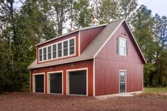 a red barn with two garages in the front and one car attached to it