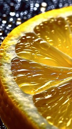 an orange sliced in half with water droplets on it