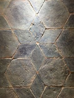 an image of a stone floor with hexagonal tiles on it's sides