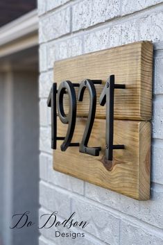 a house number sign mounted to the side of a building