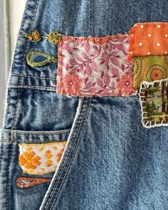 the back pocket of a pair of jeans with patchwork and floral designs on them