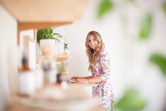 a woman standing in front of a counter top