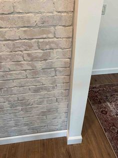 a white brick wall in the corner of a room