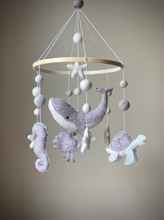 a baby mobile with sea animals hanging from it