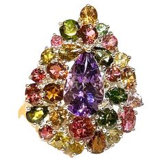 Bochic "Orient” Amethyst & Multi Tourmaline Cocktail Ring 18K Gold & Silver Natural Pear Shape Amethyst - 7 Carat Natural Multi Color Tourmaline - 17.50 Carat This Ring is from the "Orient" traveling collection are the epitome of elegance and versatility. It offers a perfect blend of day to night and swimwear to evening wear, allowing you to effortlessly transition between different occasions and outfits. Wearing these spectacular oriental-style ring will undoubtedly make you the center of attention. It addw a touch of glamour and sophistication to your favorite caftans, swimwear, or evening attire, enhancing your overall look. The "Orient" collection, from which this ring originates, showcases exceptional craftsmanship and incorporates natural gemstones. The ring is set in 18k gold and si Multicolor Luxury Amethyst Ring, Luxury Multicolor Amethyst Ring Fine Jewelry, Luxury Multicolor Amethyst Jewelry, Luxury Multi-stone Gold Amethyst Ring, Exquisite Multi-stone Amethyst Jewelry, Cocktail Ring, Pear Shape, Cocktail Rings, Gold And Silver