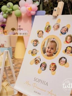 a baby's first birthday party with pictures on the sign and balloons in the background