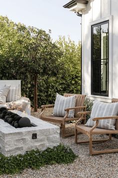 an outdoor living area with chairs and fire pit