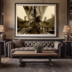 a living room with couches, lamps and pictures hanging on the wall above them